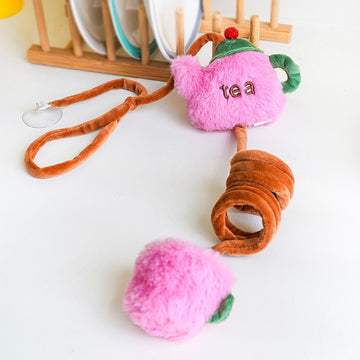 ZEZE Tea Time pink plush teapot and teacup hanging toy on a kitchen counter