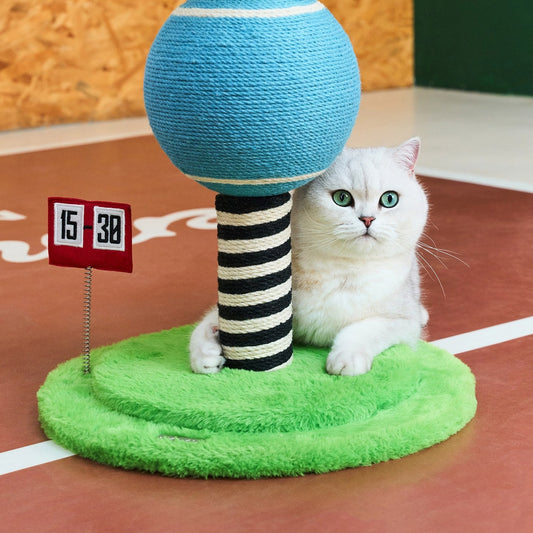 Cat lounging on the plush green base beside the striped post and scoreboard
