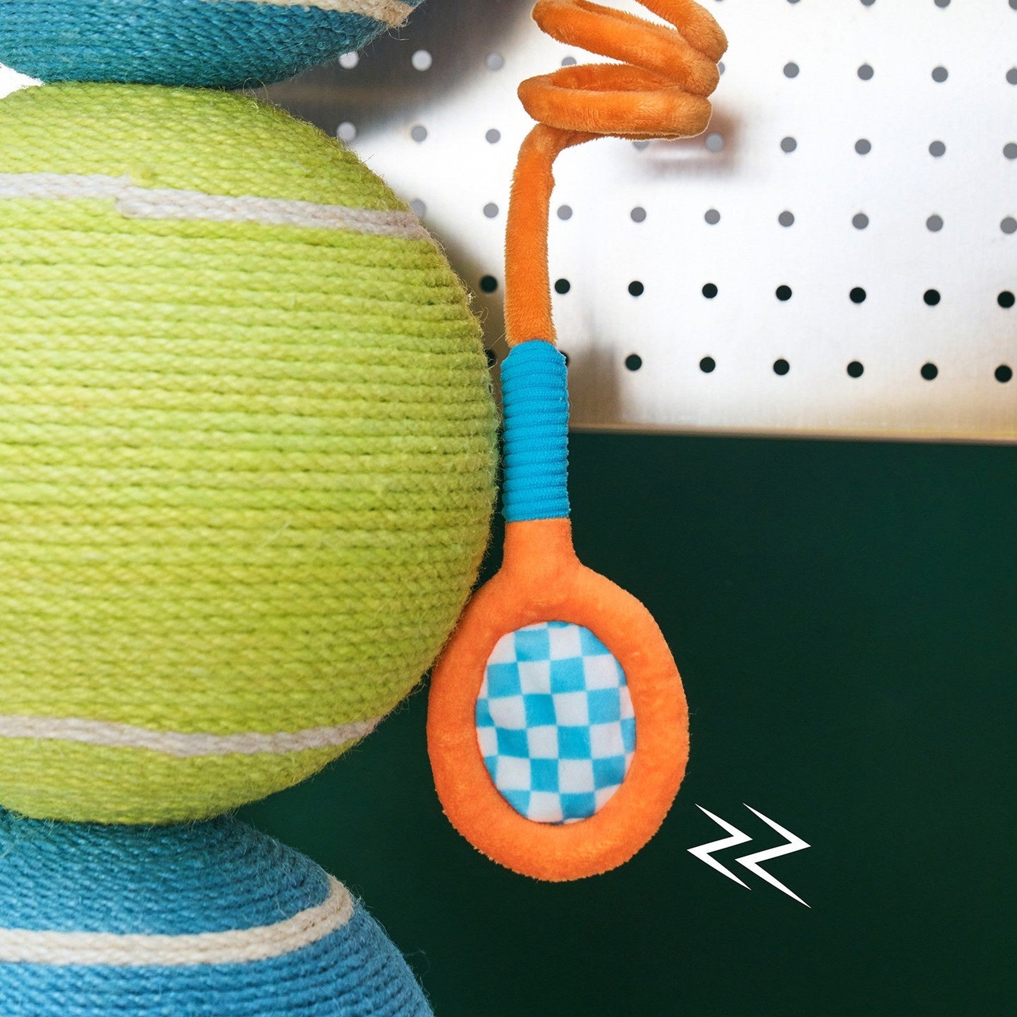 Close-up of the mini tennis racket toy on its elastic cord