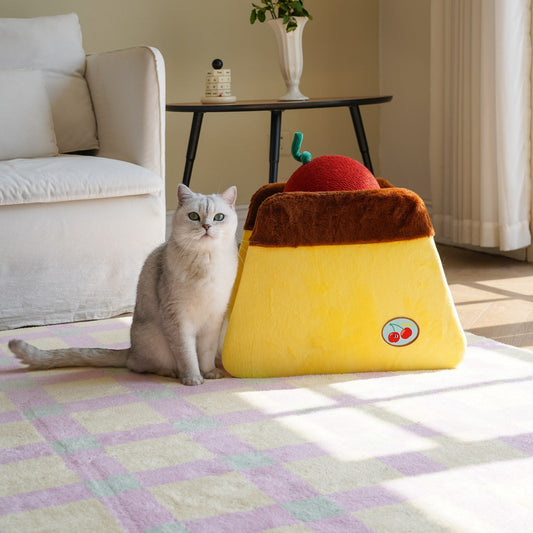 Cat sitting beside the ZEZE Cherry Pudding cat scratcher in a sunny living room