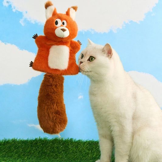 White cat nuzzling the Finn the Red Squirrel plush toy