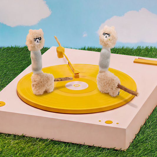 Two alpaca cat toys on a yellow record player