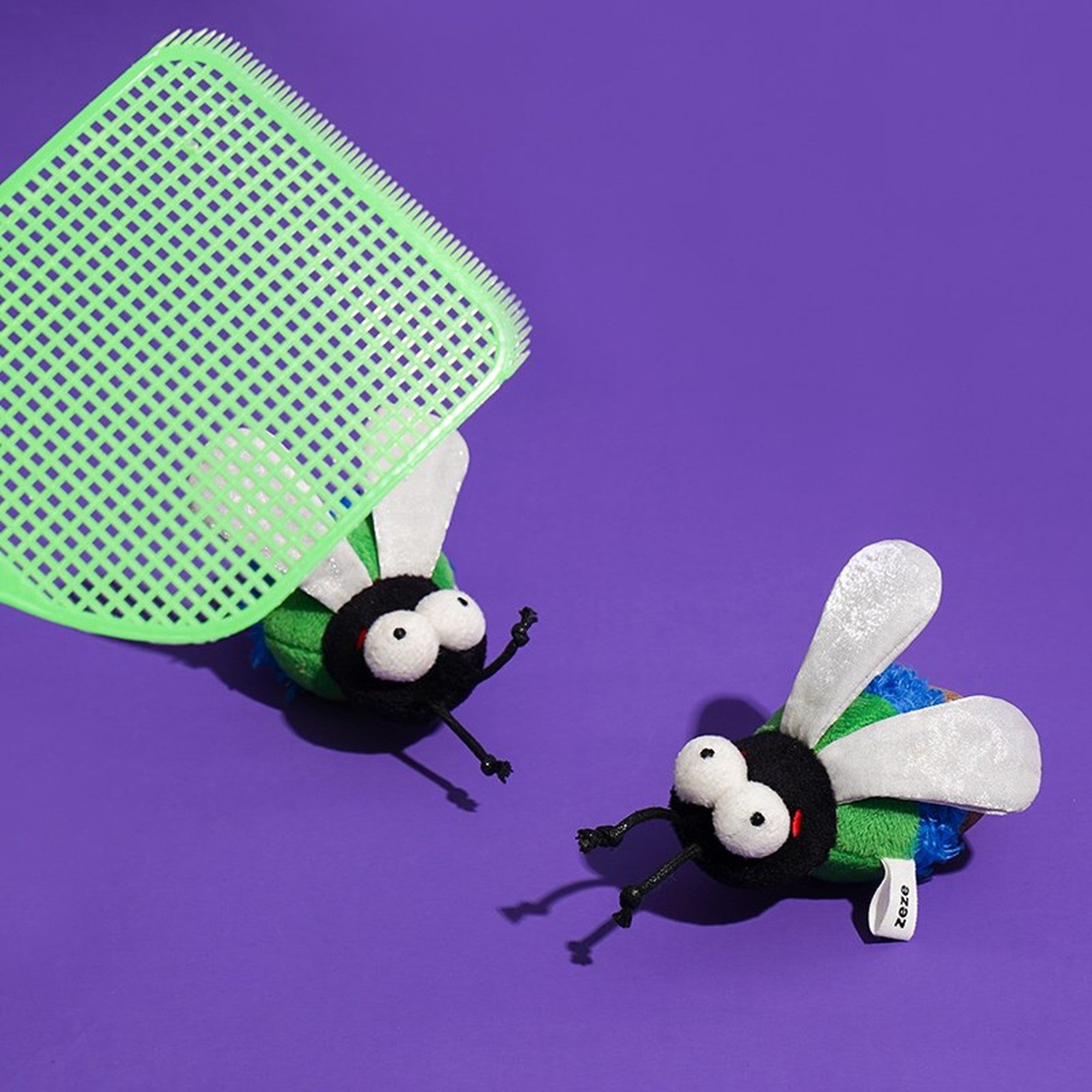 Two Green Fly toys with a green fly swatter