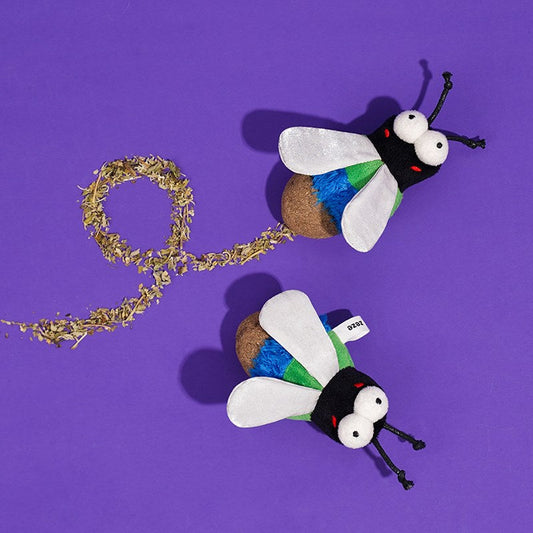 Two Green Fly toys with a trail of loose catnip