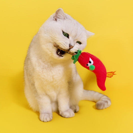 White cat biting the ZEZE Hot Chili silvervine cat toy