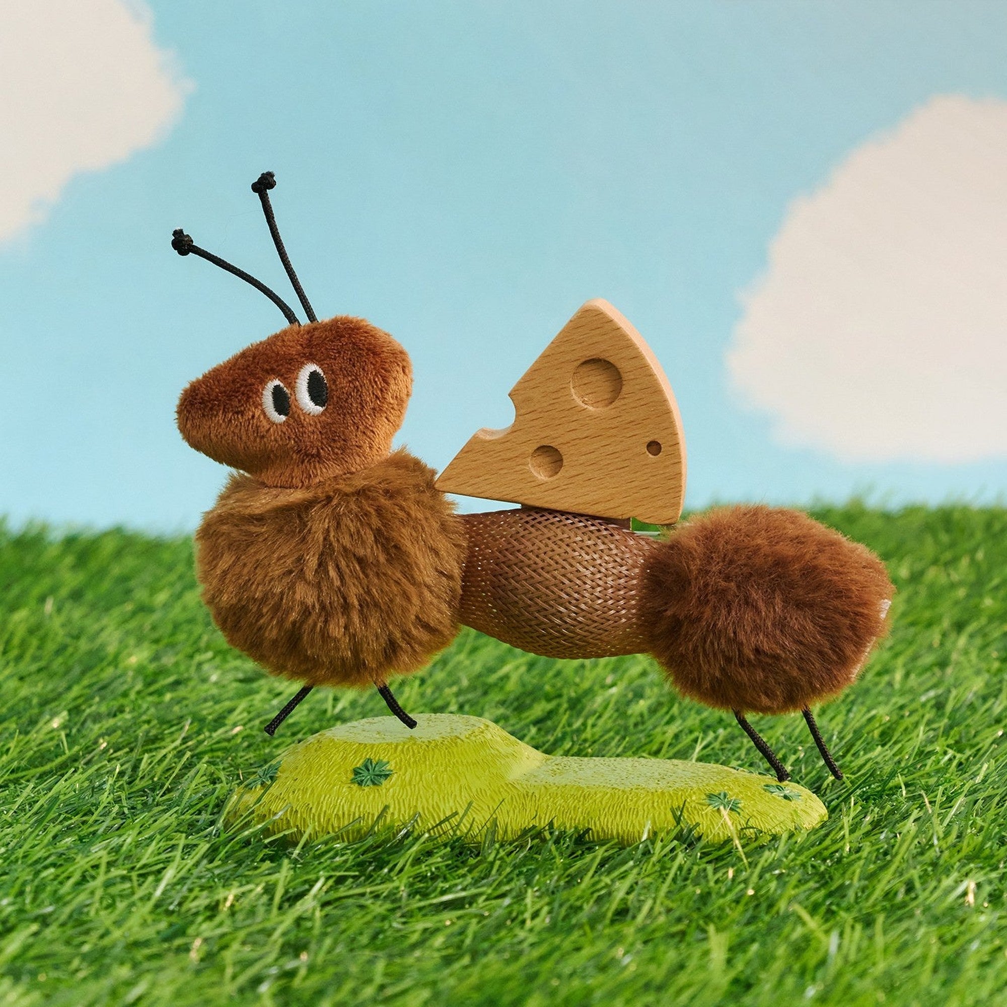 Little Ant cat toy carrying a wooden cheese wedge