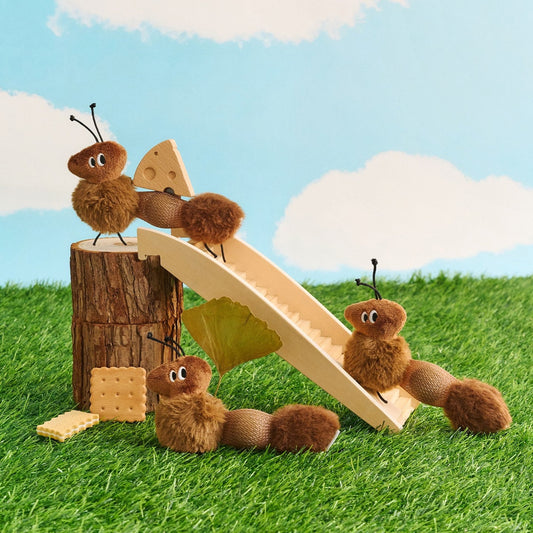 Ant cat toys playing on a wooden slide