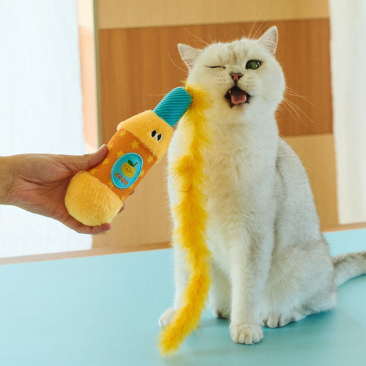 White cat playing with the ZEZE Orange Popper feather cat toy