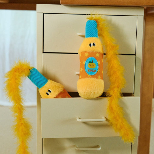 Orange Popper cat toy peeking out of a drawer