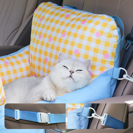 Cat resting in the car seat bed secured with the seat strap