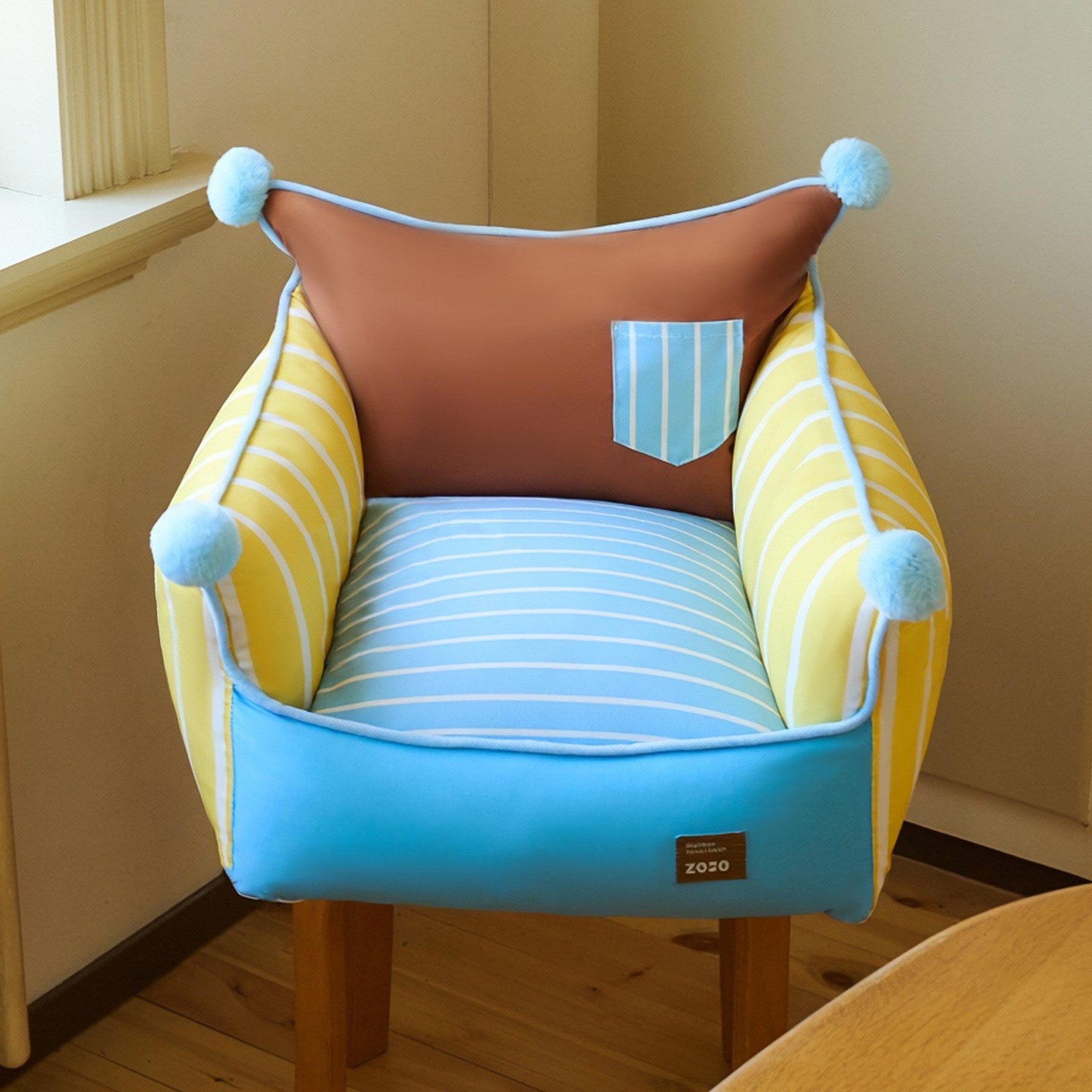 Pompom pet sofa set on a chair in a bright corner