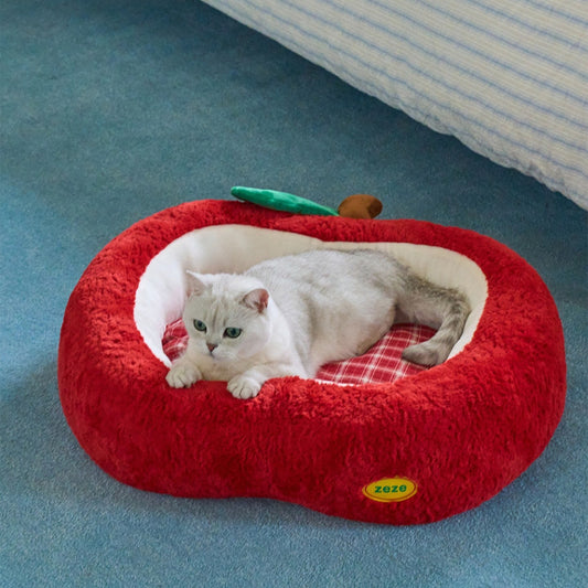 Cat lounging on the red plaid cushion of the apple bed