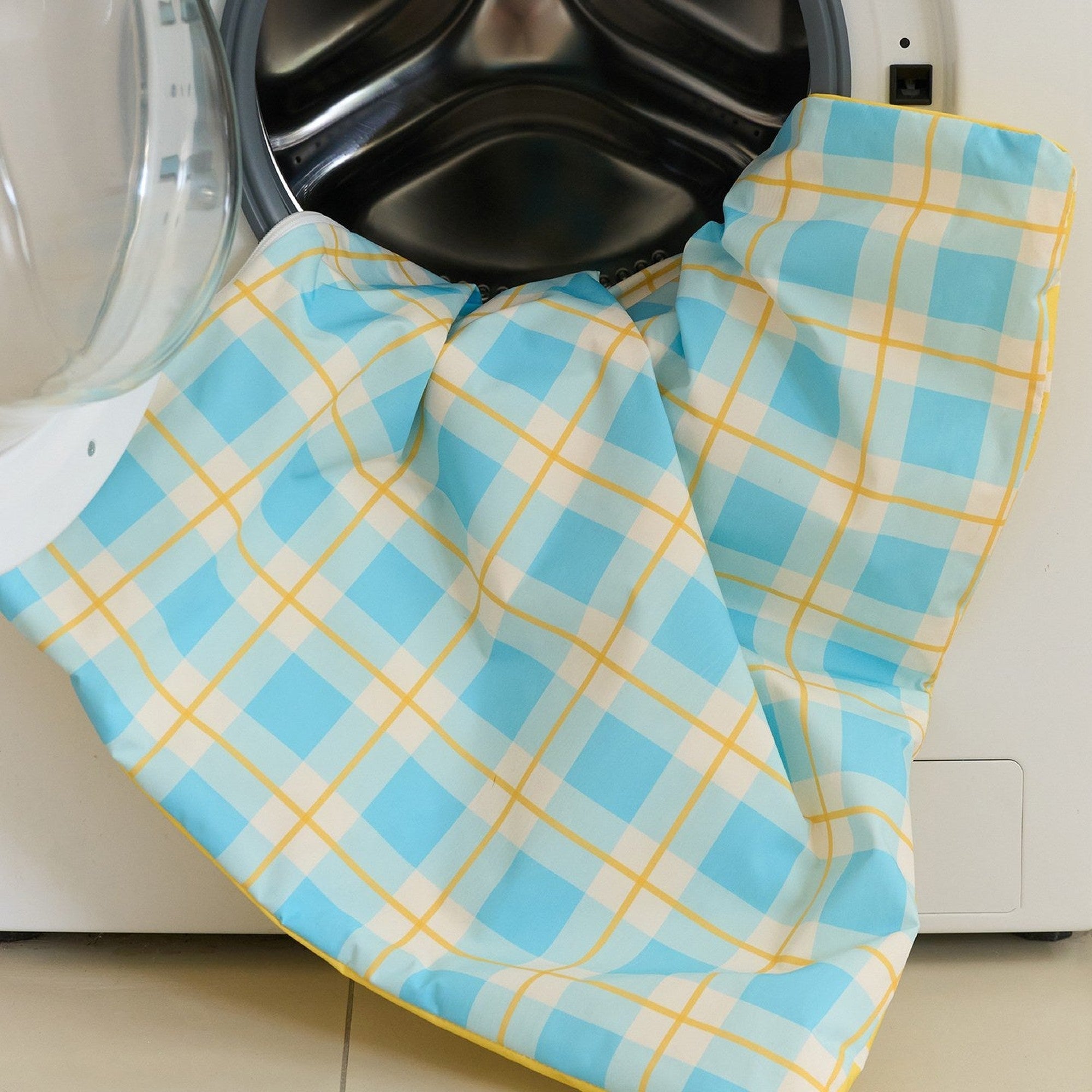 Removable plaid cushion cover going into the washing machine