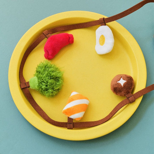 Plush snack charms on a yellow plate