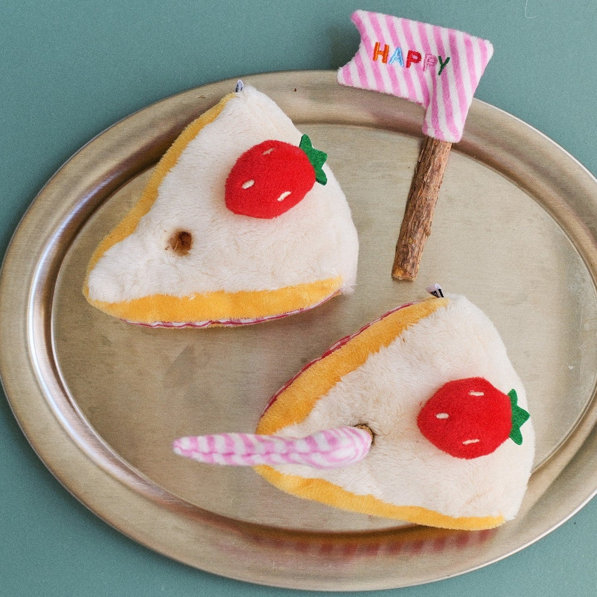 Cake cat toys on a silver tray with the stick removed