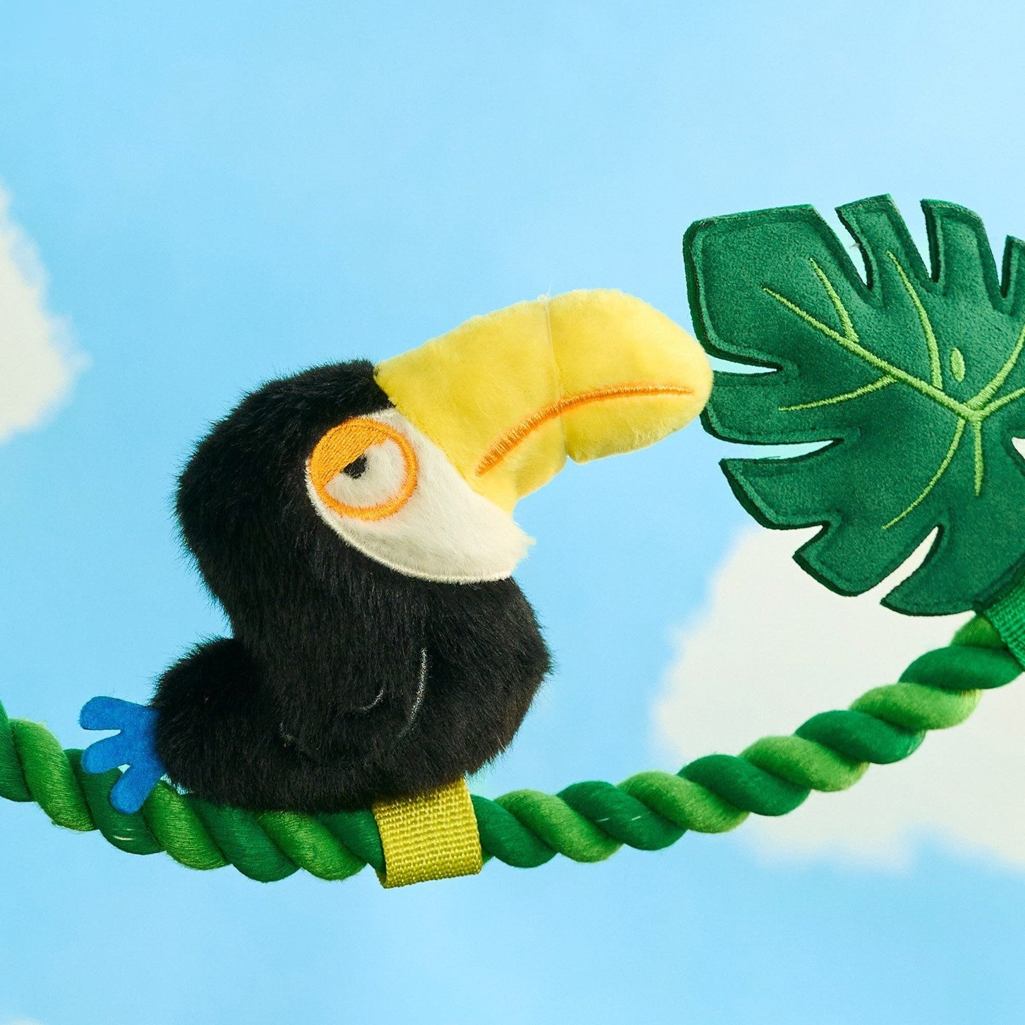 Close-up of the plush toucan perched on the rope vine